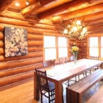 A dining room table with chairs and a bench