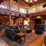 A living room with a couch, chair and television.